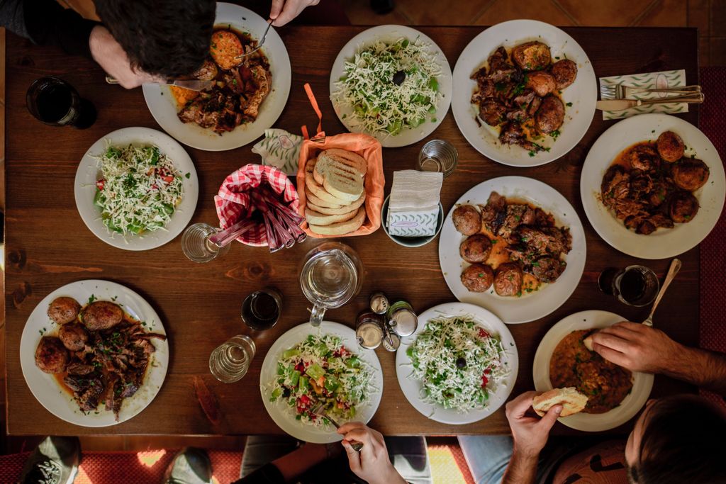 Looking down on a dinner party table with indian dishes
